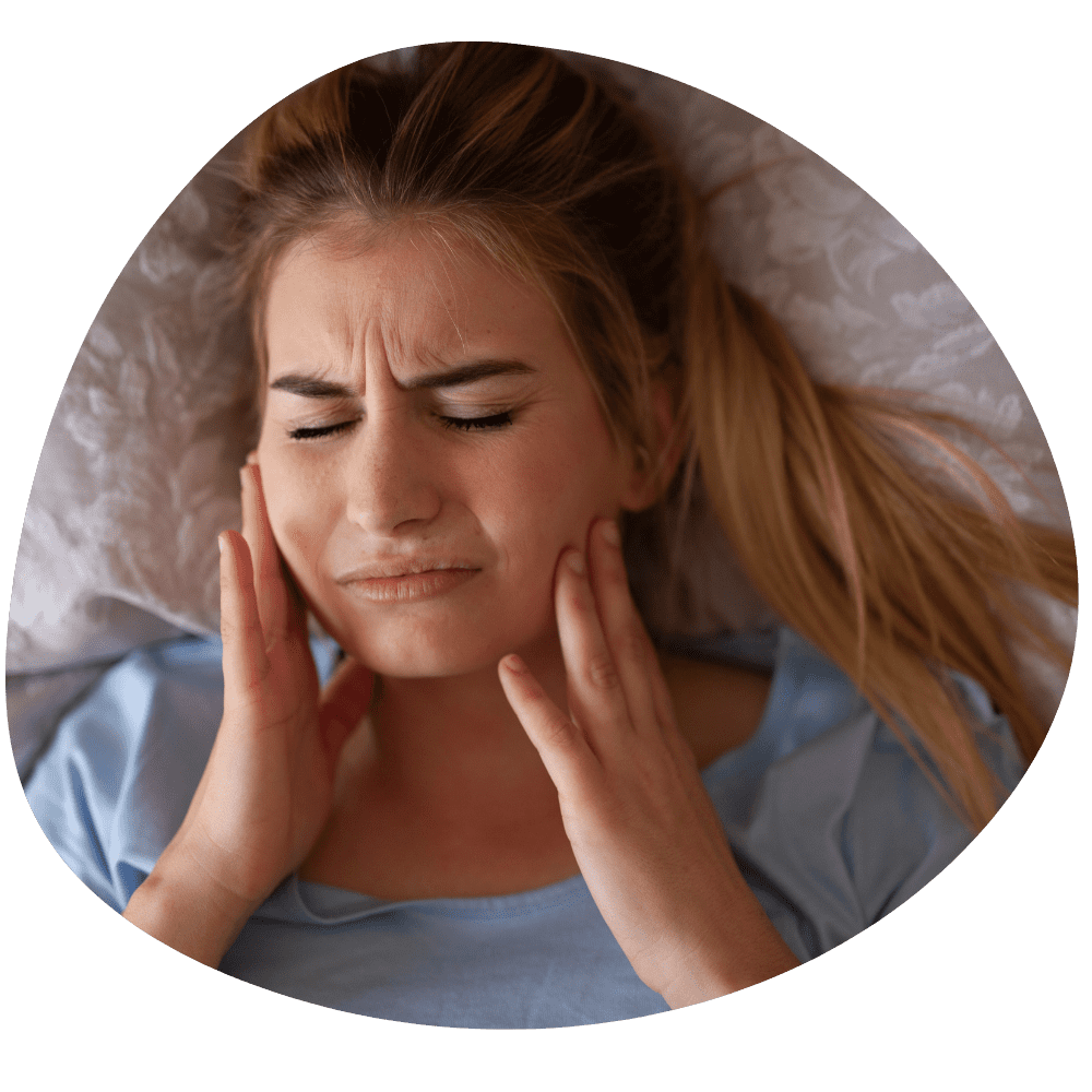 TMJ headache with a person rubbing their jaw